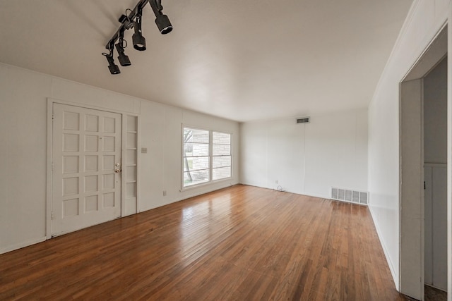 interior space with wood finished floors and visible vents