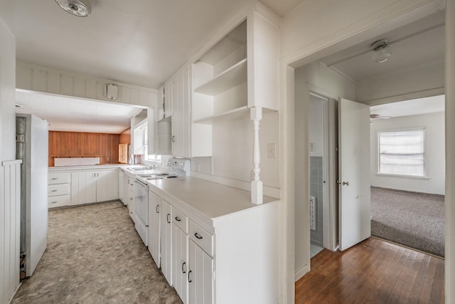 kitchen featuring electric stove, open shelves, light countertops, white cabinets, and a sink