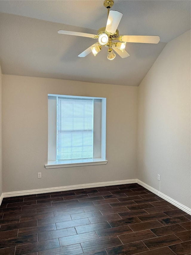 unfurnished room with wood tiled floor, baseboards, and vaulted ceiling