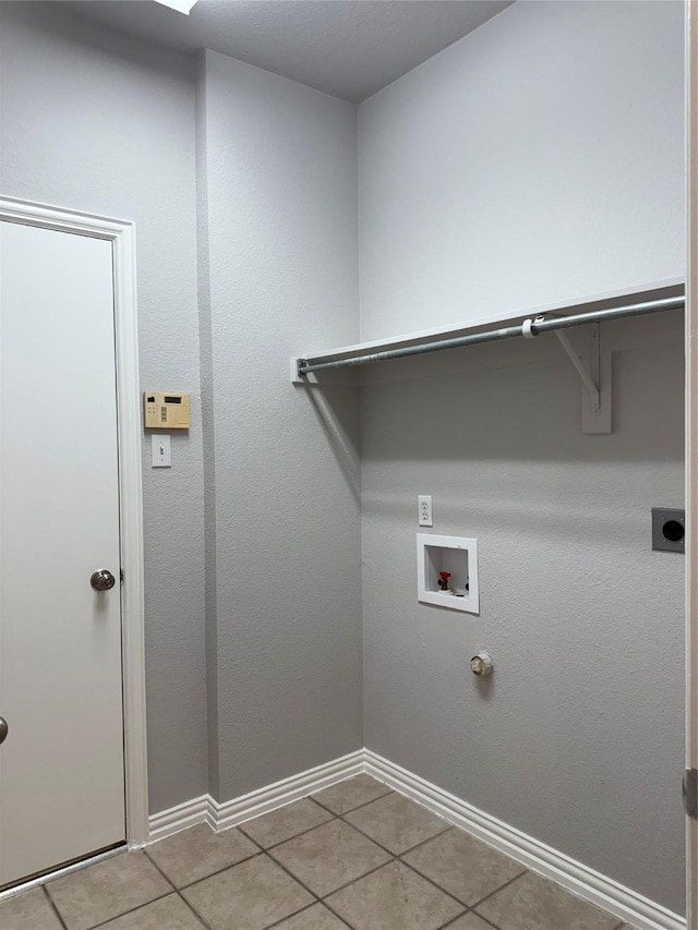 laundry area with laundry area, light tile patterned floors, baseboards, hookup for a washing machine, and hookup for an electric dryer