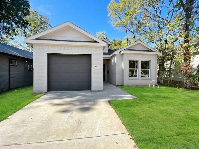 view of front of home featuring driveway, brick siding, a garage, and a front yard