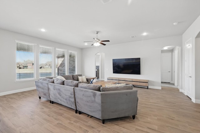 4303 Juniper Ln, Melissa, TX 75454 - living room featuring light wood-style flooring, a ceiling fan, recessed lighting, arched walkways, and baseboards