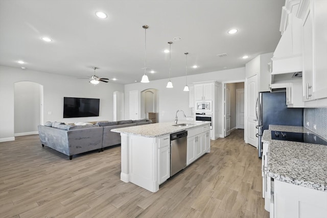 4303 Juniper Ln, Melissa, TX 75454 - kitchen with a sink, white cabinetry, stainless steel appliances, arched walkways, and ceiling fan