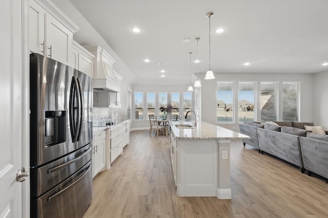 4303 Juniper Ln, Melissa, TX 75454 - kitchen with stainless steel refrigerator with ice dispenser, a sink, open floor plan, white cabinets, and black electric cooktop