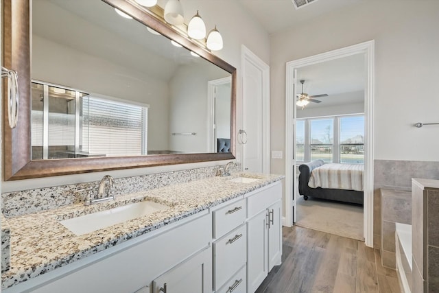 4303 Juniper Ln, Melissa, TX 75454 - bathroom featuring ceiling fan, double vanity, wood finished floors, and a sink