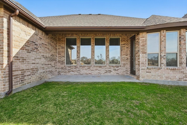4303 Juniper Ln, Melissa, TX 75454 - exterior space with a lawn, roof with shingles, brick siding, and a patio area