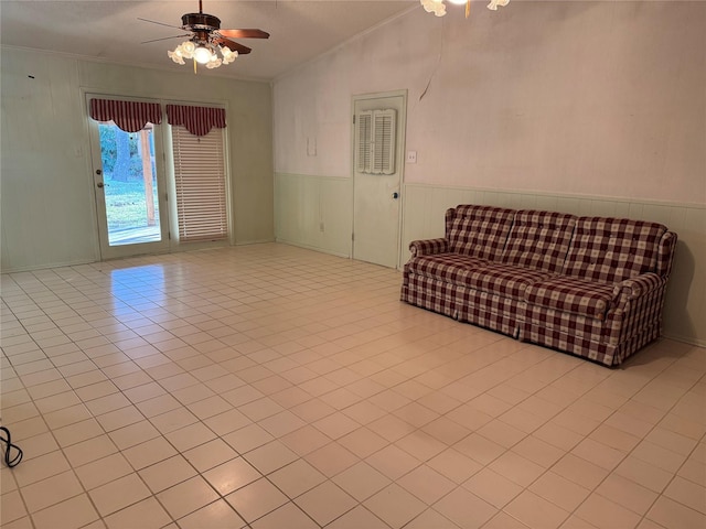 unfurnished room featuring tile patterned flooring, ornamental molding, vaulted ceiling, and a ceiling fan