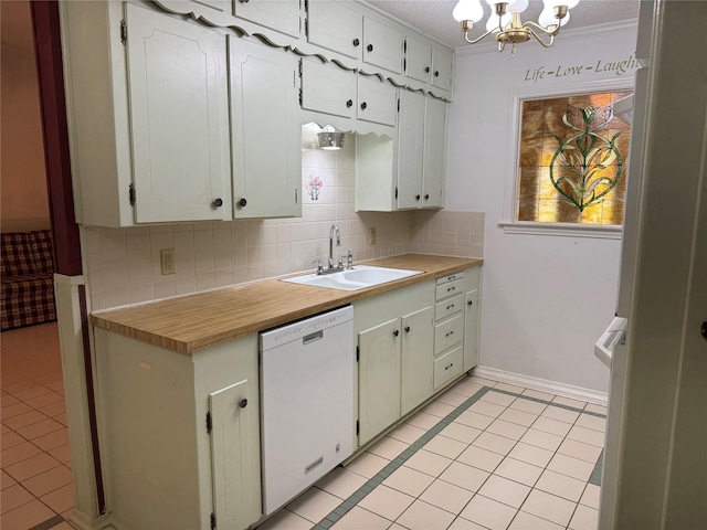 kitchen featuring light tile patterned floors, tasteful backsplash, dishwasher, a notable chandelier, and a sink