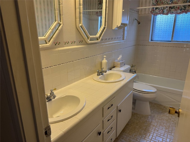 bathroom featuring a sink, tile walls, toilet, and shower / bathing tub combination