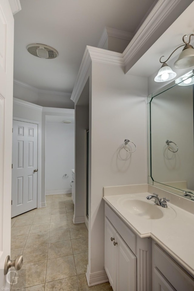 bathroom featuring visible vents, crown molding, vanity, and tile patterned floors