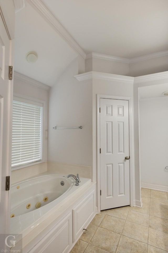 full bathroom featuring baseboards, ornamental molding, tile patterned floors, a jetted tub, and vaulted ceiling