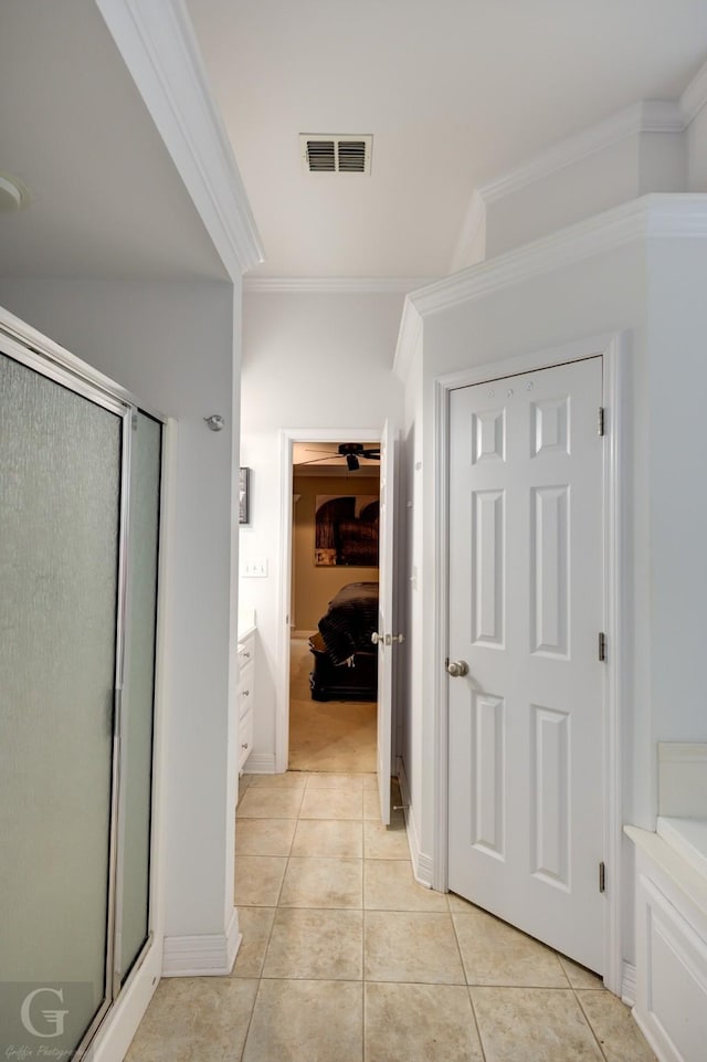 full bath with crown molding, a shower stall, visible vents, and tile patterned floors