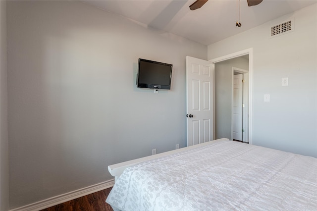 bedroom featuring baseboards, visible vents, ceiling fan, and dark wood-type flooring