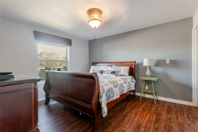 bedroom with baseboards and wood finished floors