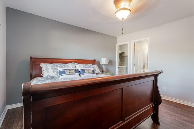 bedroom with dark wood-type flooring and baseboards