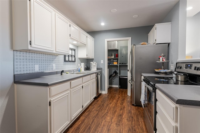 kitchen featuring dark wood-style floors, stainless steel appliances, backsplash, white cabinets, and a sink