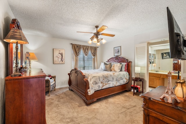 bedroom featuring a textured ceiling, baseboards, a ceiling fan, and light colored carpet