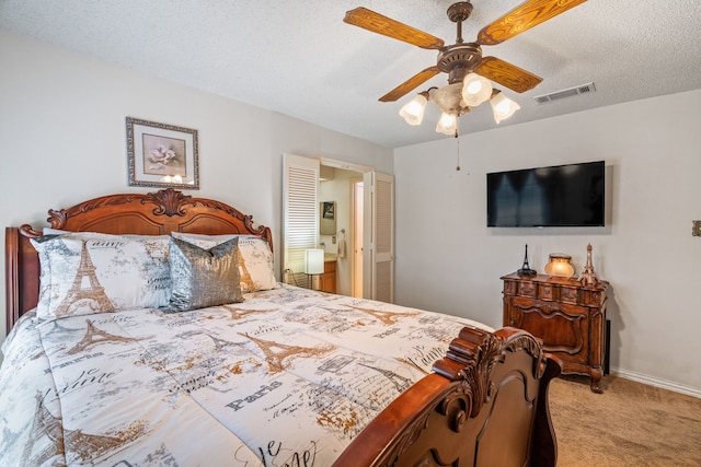 bedroom featuring visible vents, a ceiling fan, carpet flooring, a textured ceiling, and baseboards