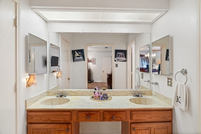 bathroom with a sink and double vanity