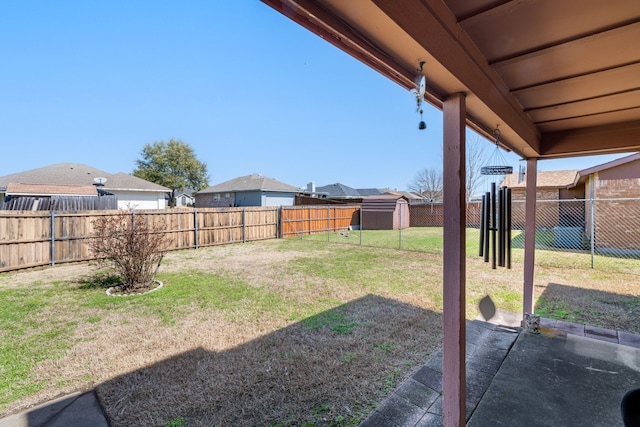 view of yard with a patio, an outdoor structure, and a fenced backyard