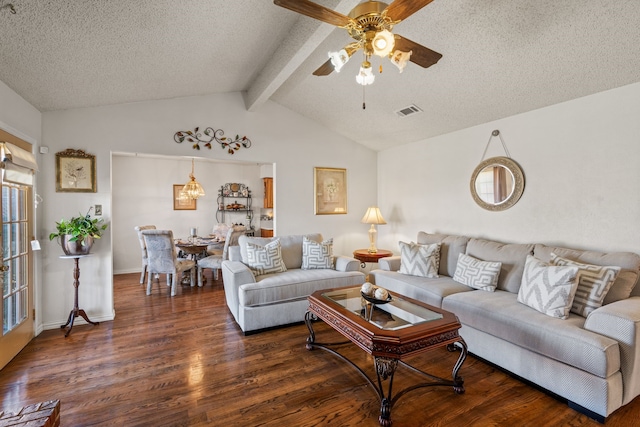 living room featuring visible vents, dark wood finished floors, a ceiling fan, lofted ceiling with beams, and a textured ceiling