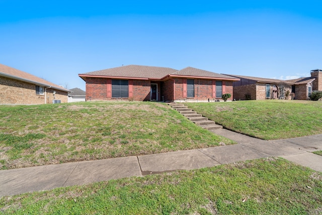 ranch-style home with brick siding and a front lawn