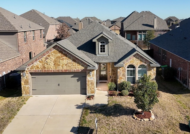 view of front of house featuring stone siding, concrete driveway, a garage, and a shingled roof