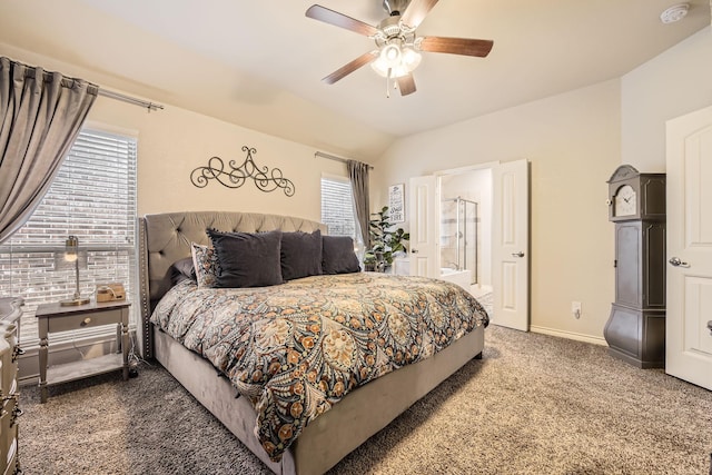 carpeted bedroom with ensuite bath, vaulted ceiling, a ceiling fan, and baseboards