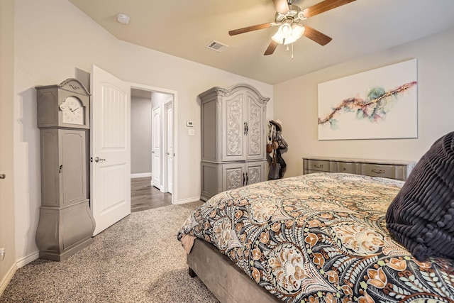 carpeted bedroom with visible vents, a ceiling fan, and baseboards