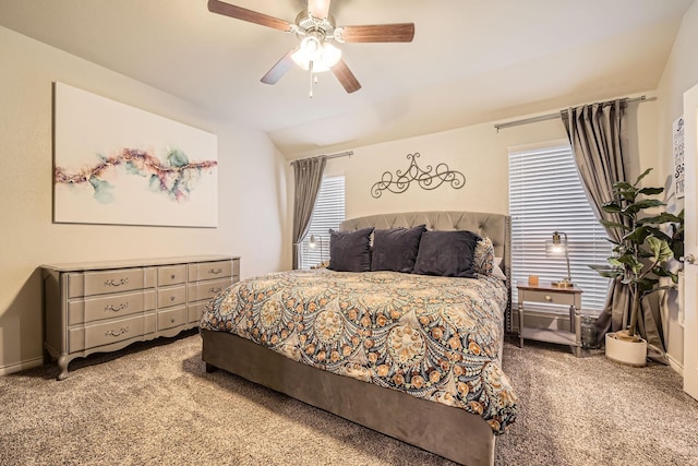 bedroom with lofted ceiling, carpet flooring, baseboards, and ceiling fan