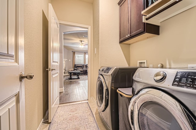 clothes washing area with washer and clothes dryer, light tile patterned floors, cabinet space, and a ceiling fan