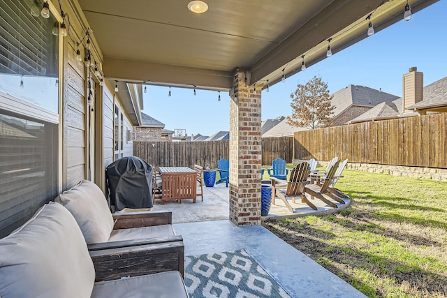 view of patio featuring outdoor lounge area, area for grilling, and a fenced backyard