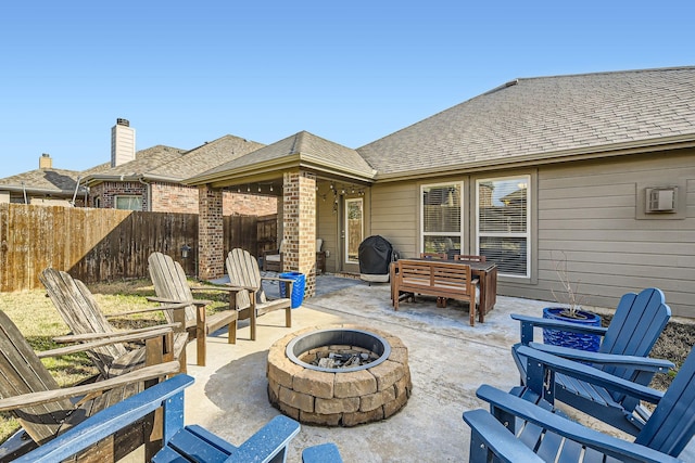 view of patio / terrace with fence and an outdoor fire pit