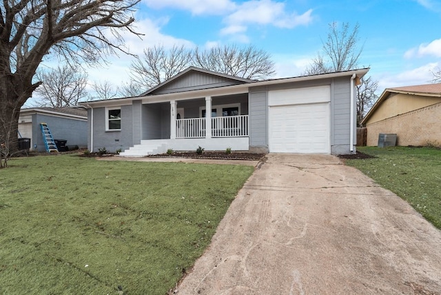 ranch-style house featuring a garage, covered porch, driveway, and a front yard