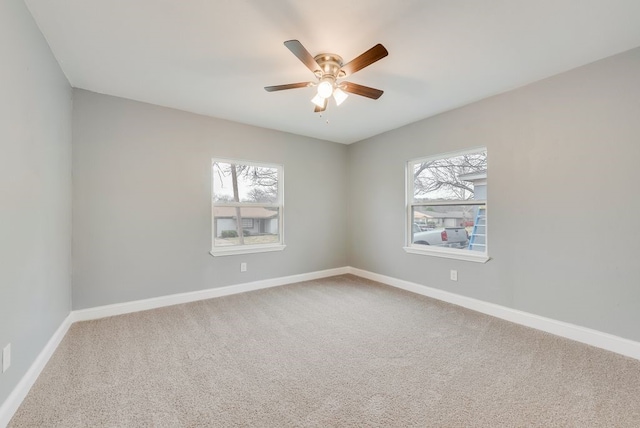 unfurnished room with carpet, baseboards, and ceiling fan