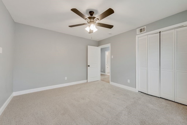 unfurnished bedroom with carpet floors, visible vents, ceiling fan, and baseboards