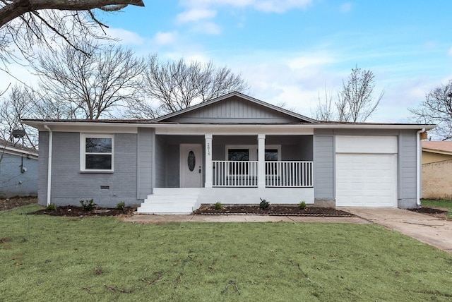 ranch-style home featuring a garage, driveway, a front lawn, and covered porch