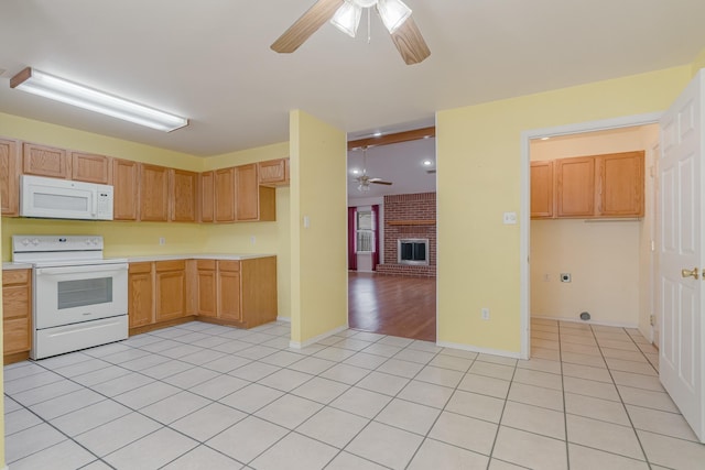 kitchen featuring white appliances, light countertops, ceiling fan, and light tile patterned floors