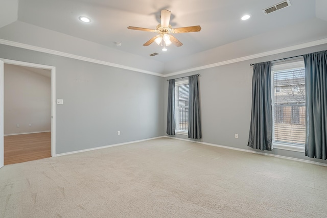 empty room featuring baseboards, a healthy amount of sunlight, visible vents, and light colored carpet