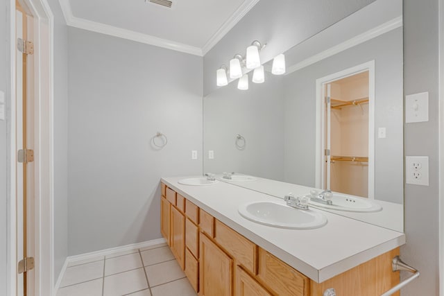 full bathroom with double vanity, ornamental molding, a sink, and tile patterned floors