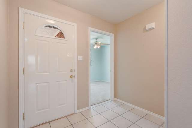 entryway with light tile patterned floors and baseboards