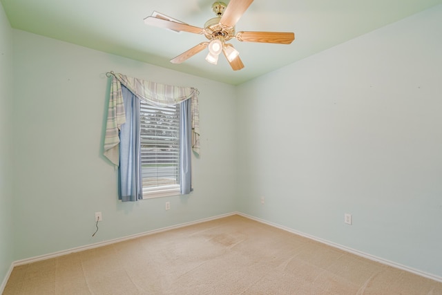 unfurnished room featuring light carpet, ceiling fan, and baseboards