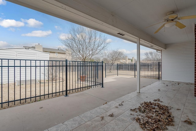 view of patio / terrace with ceiling fan and fence