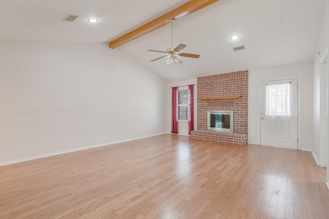 unfurnished living room with a brick fireplace, visible vents, vaulted ceiling with beams, and light wood-style flooring