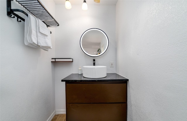 bathroom with vanity and baseboards