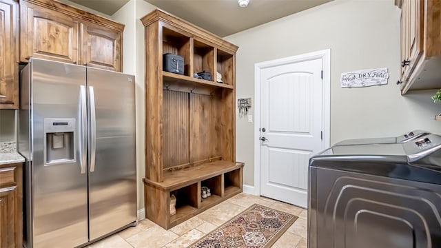 washroom with cabinet space and washer and clothes dryer