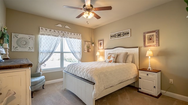 bedroom featuring light carpet, ceiling fan, and baseboards