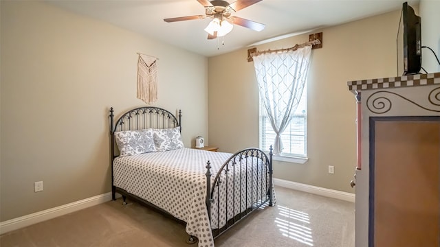 bedroom with carpet, baseboards, and a ceiling fan