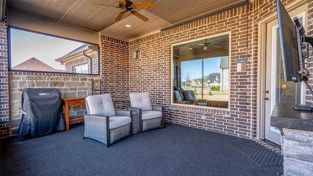 view of patio with grilling area and a ceiling fan