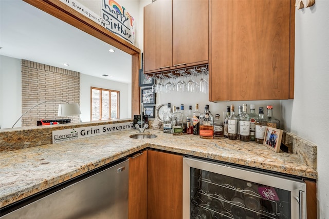 kitchen featuring light stone counters, beverage cooler, a sink, stainless steel dishwasher, and brown cabinets